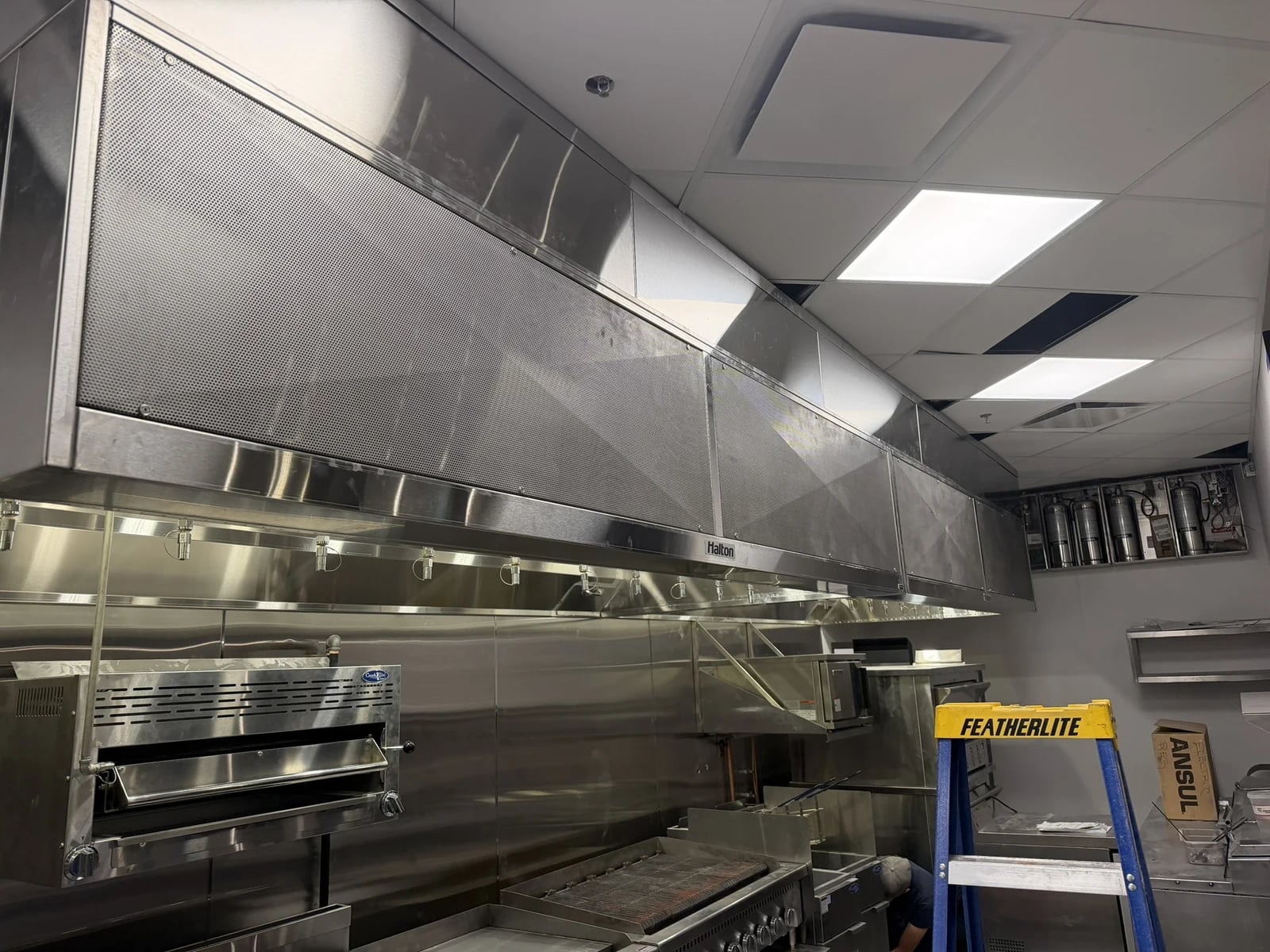 Commercial HVAC Calgary: a stainless steel kitchen exhaust hood on a TNT commercial job