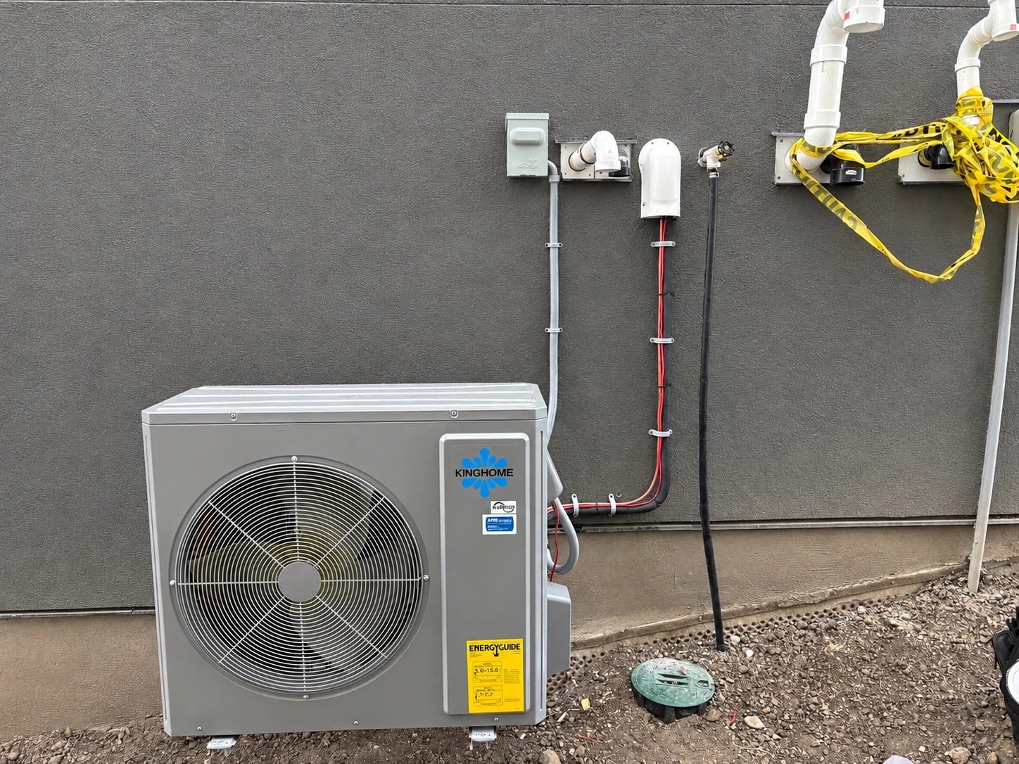 Heat pump installation Calgary: a KingHome heat pump outdoor unit installed beside a Calgary home